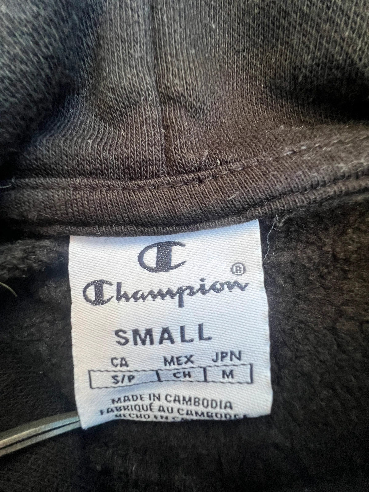 Champion black hoodie large spell out logo front, kangaroo pocket, fleece interior.