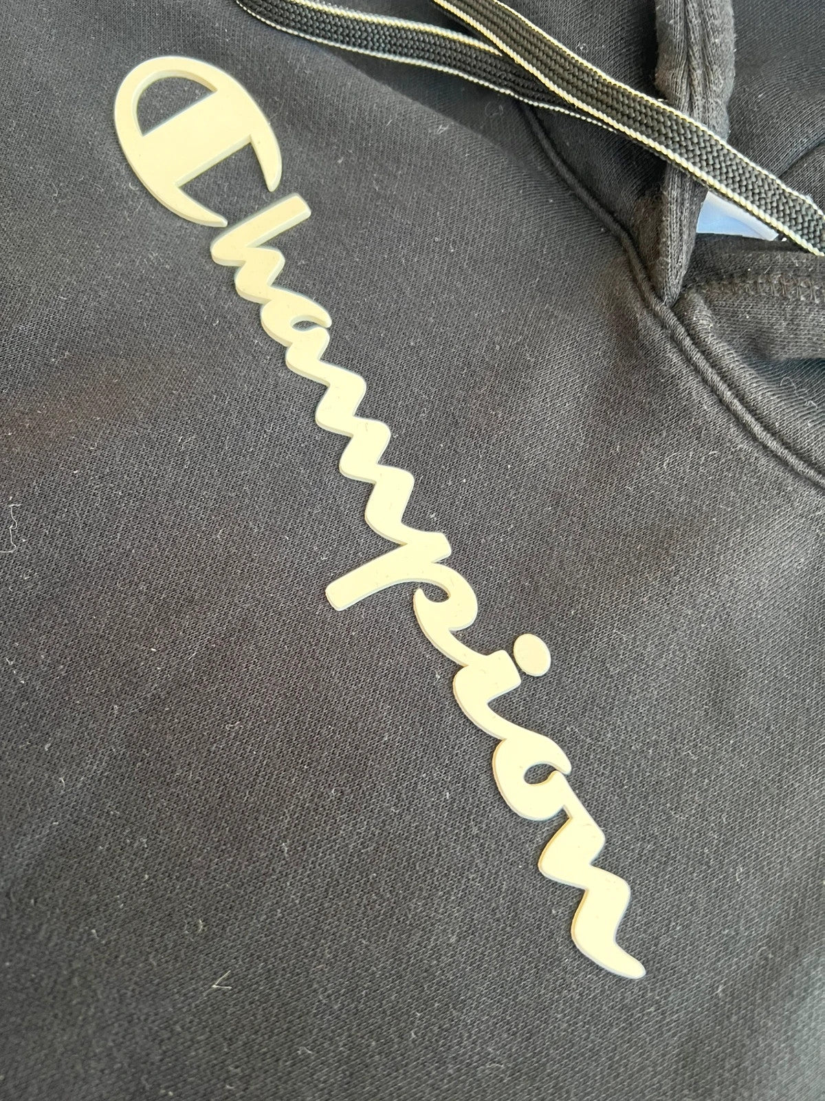 Champion black hoodie large spell out logo front, kangaroo pocket, fleece interior.