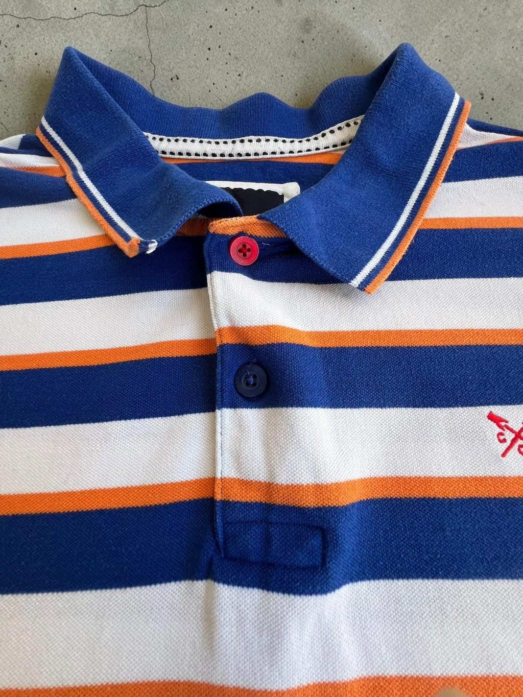 CCC men's polo shirt blue and white striped with orange accents, 100% cotton.