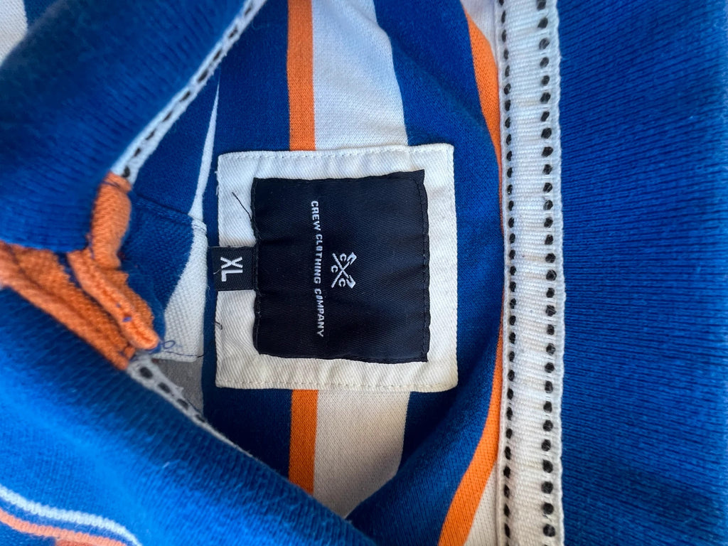 CCC men's polo shirt blue and white striped with orange accents, 100% cotton.