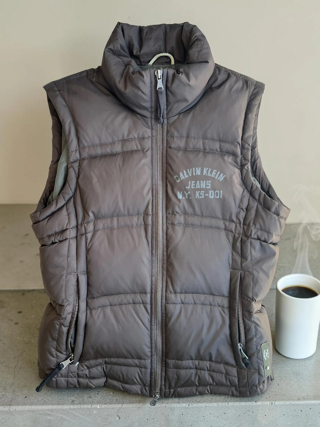 Calvin Klein brown puffer vest with duck down filling and logo detail.