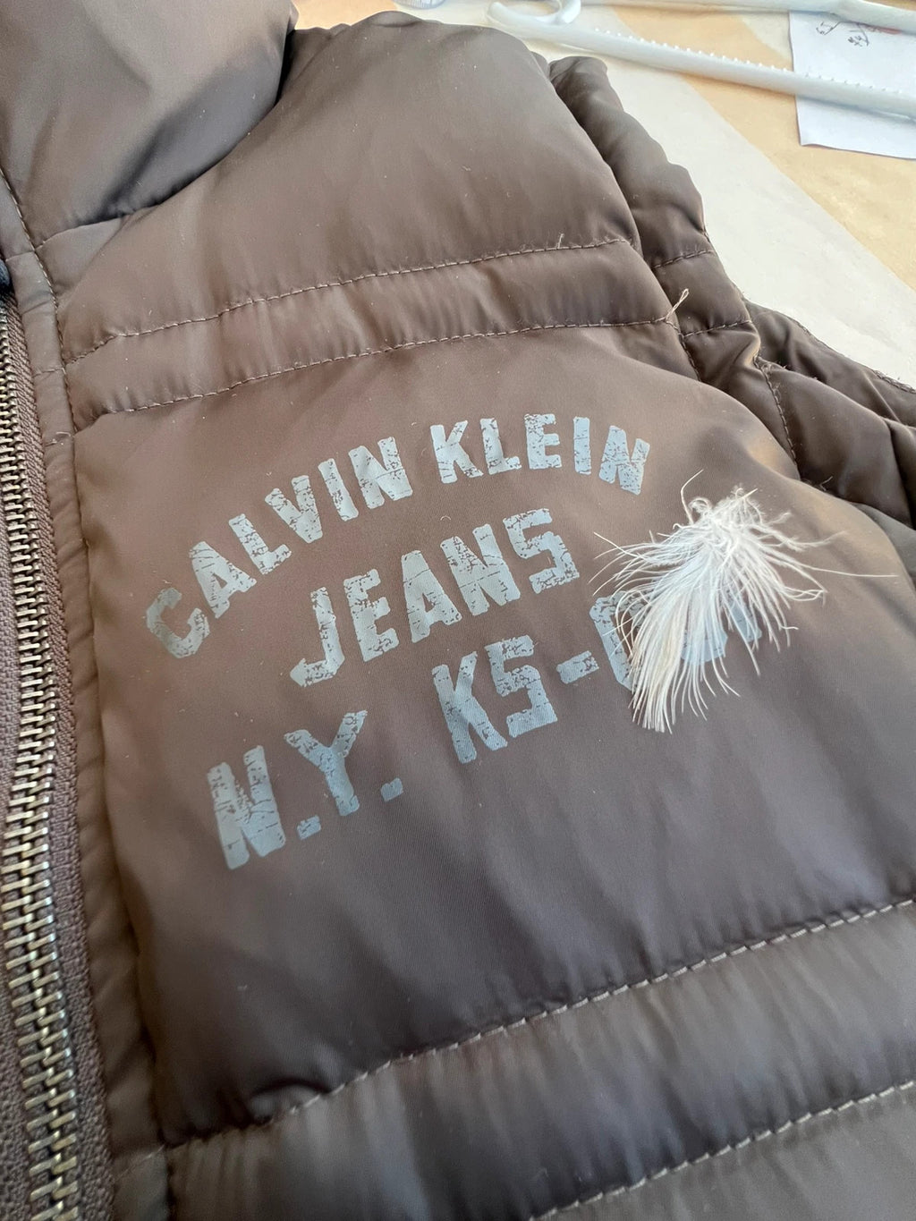 Calvin Klein brown puffer vest with duck down filling and logo detail.