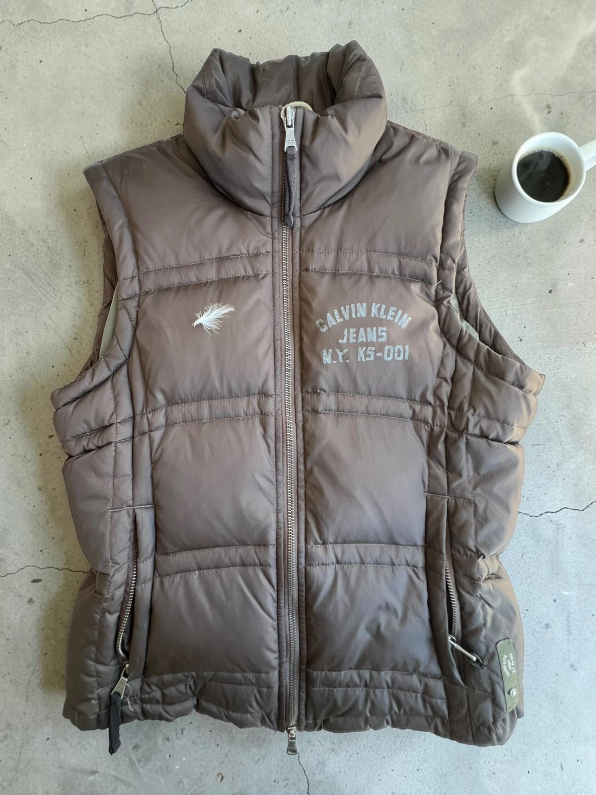 Calvin Klein brown puffer vest with duck down filling and logo detail.