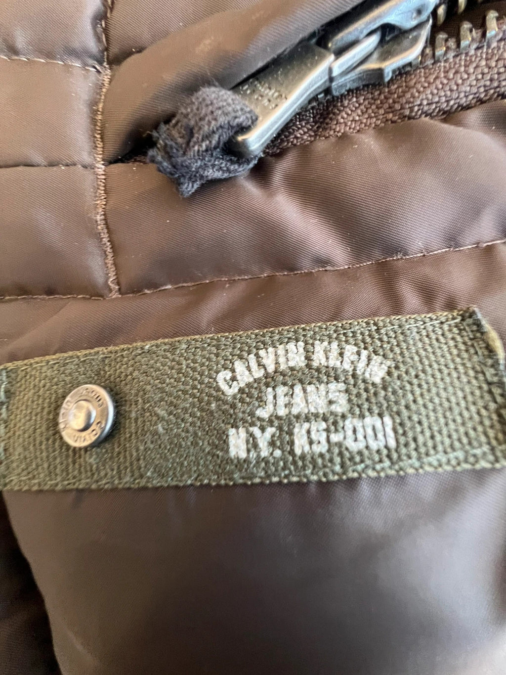 Calvin Klein brown puffer vest with duck down filling and logo detail.