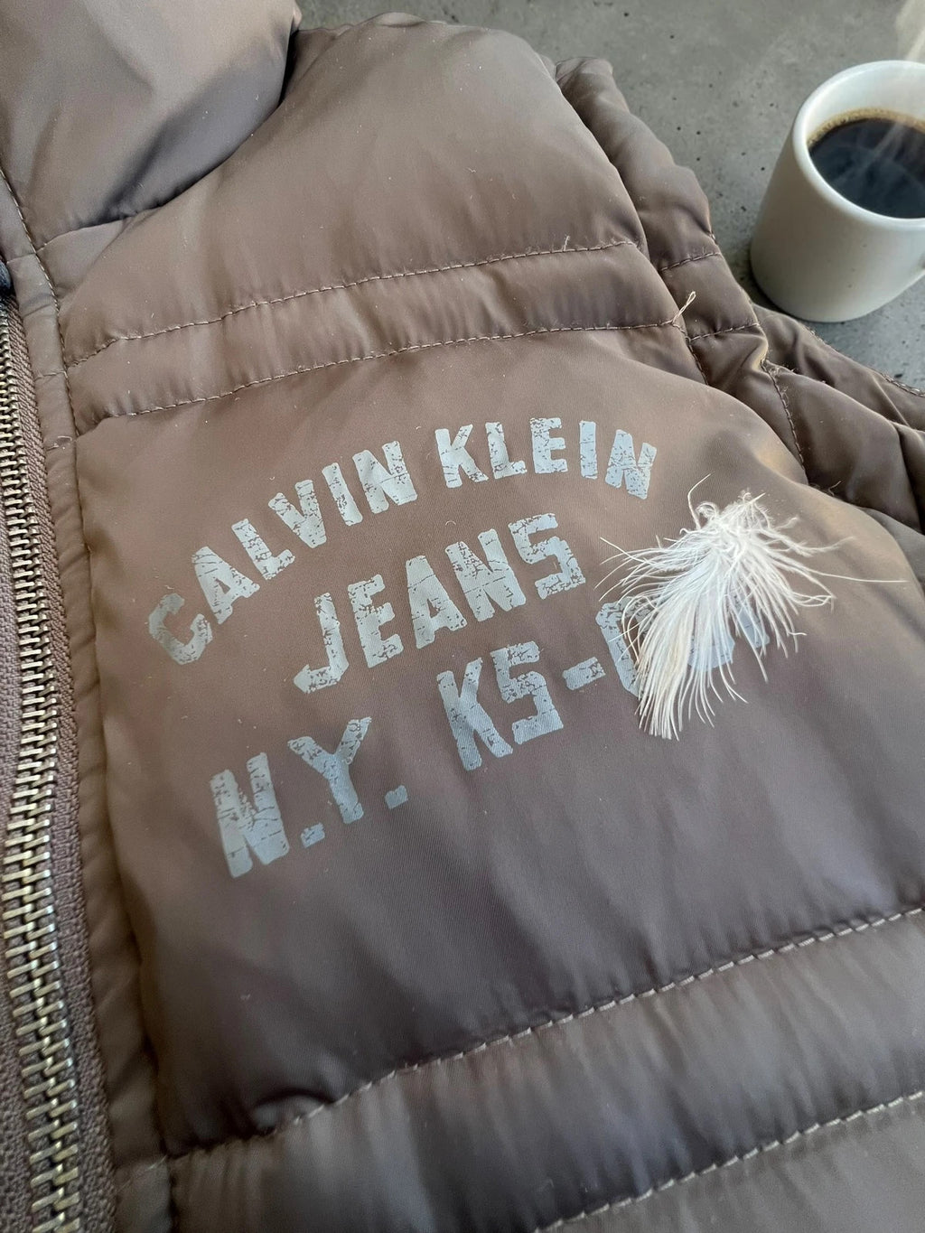Calvin Klein brown puffer vest with duck down filling and logo detail.