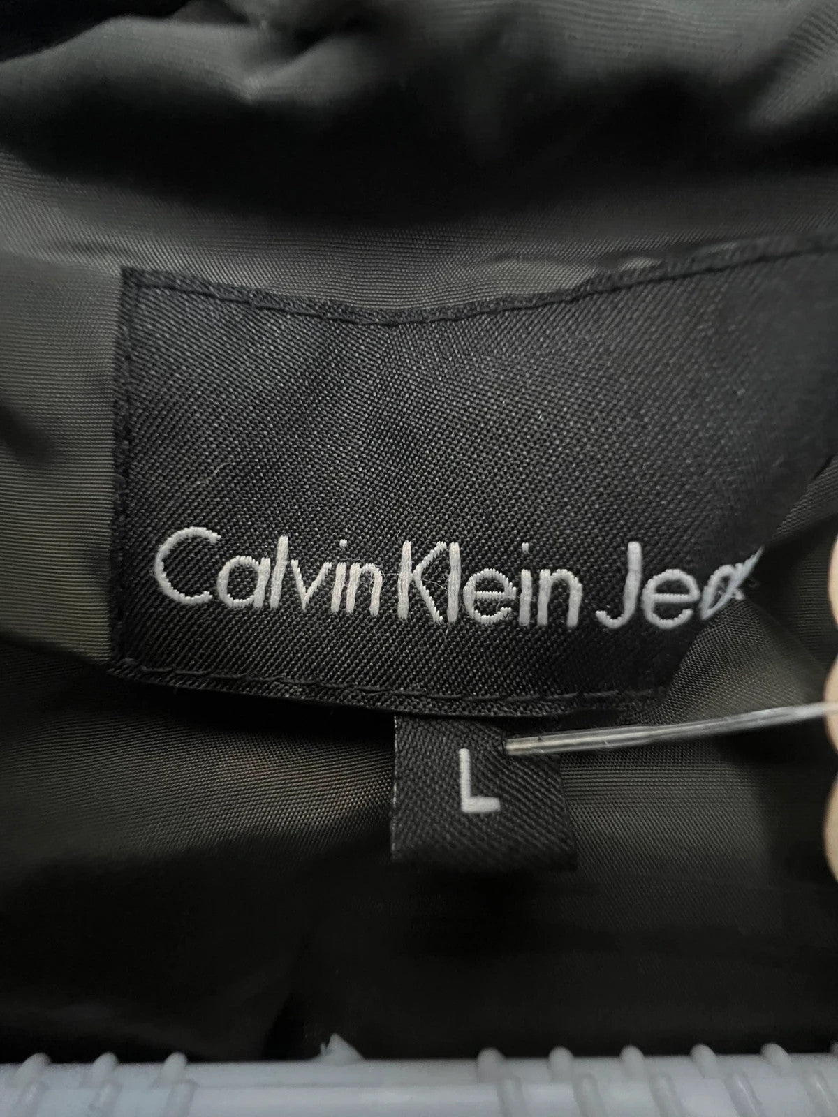 Calvin Klein brown puffer vest with duck down filling and logo detail.