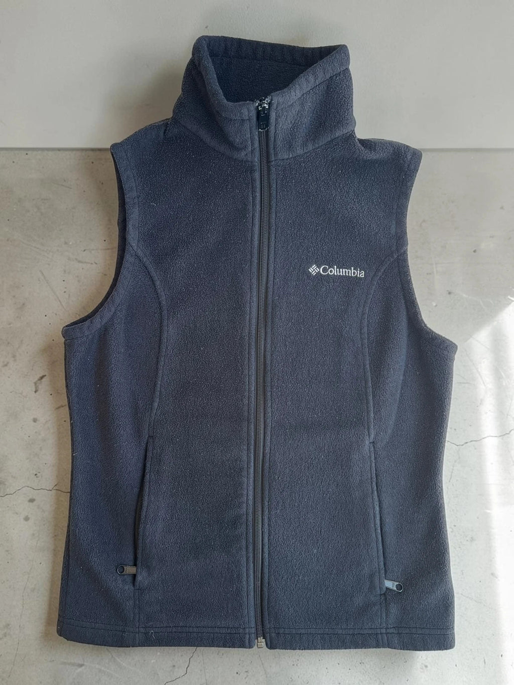 Columbia grey fleece vest with zip pockets and full front closure.