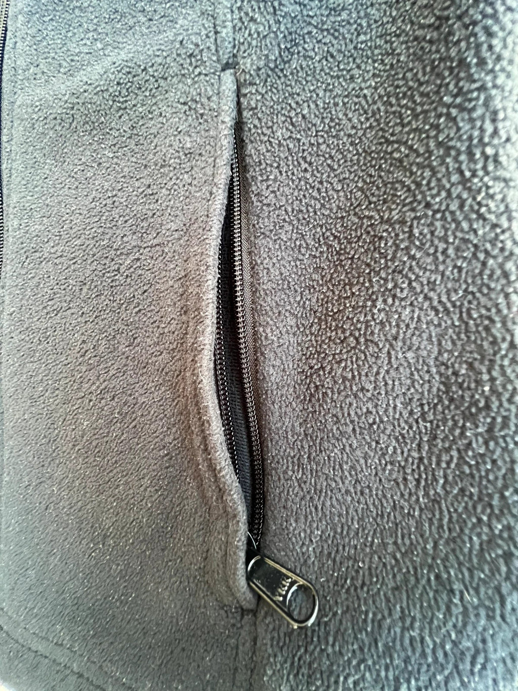 Columbia grey fleece vest with zip pockets and full front closure.