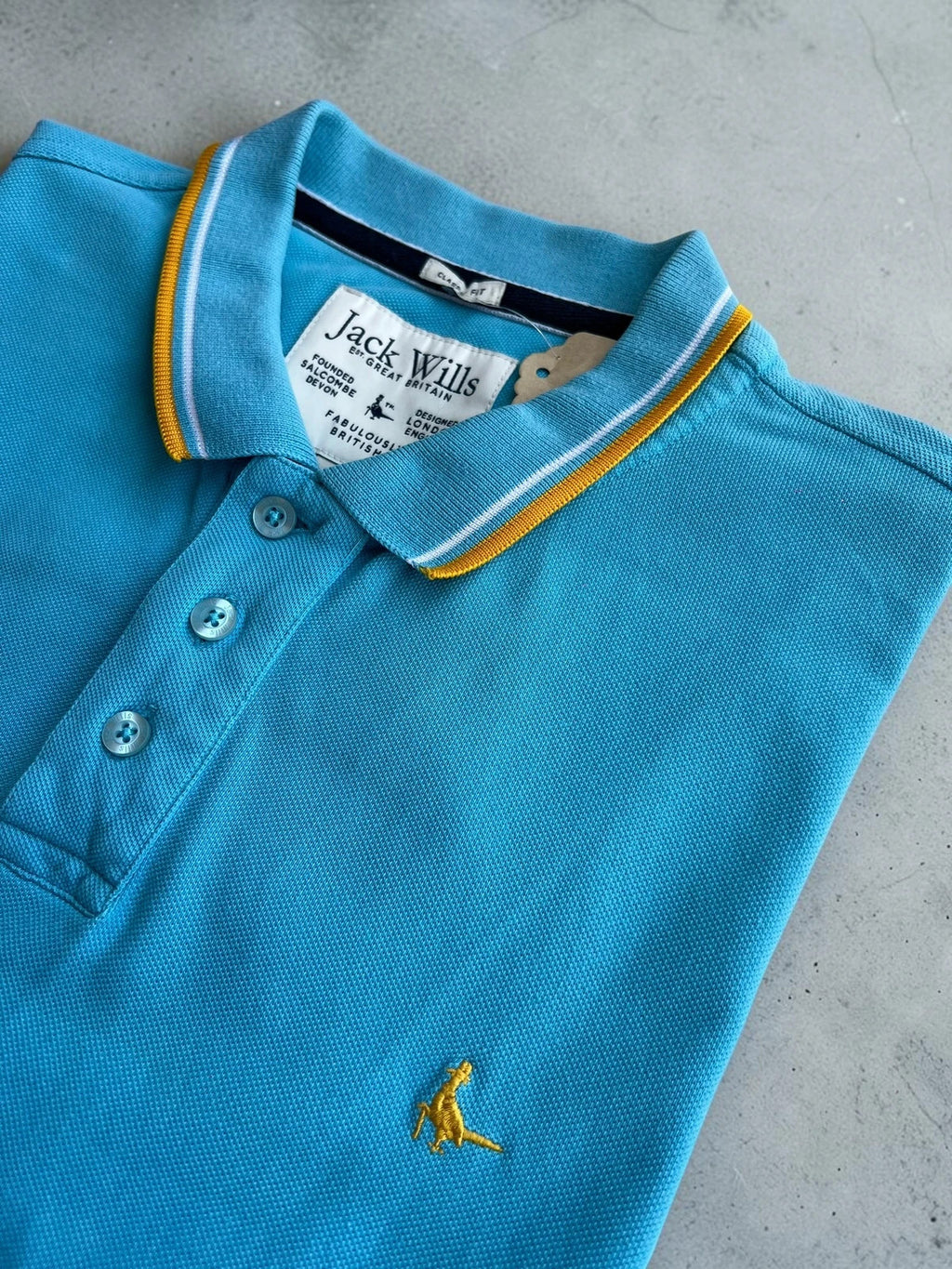 Jack Wills blue polo shirt with yellow collar and sleeve details, classic fit cotton.