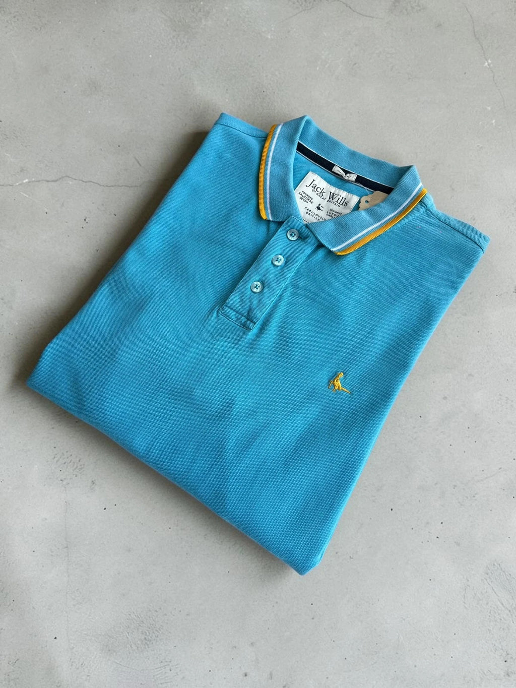 Jack Wills blue polo shirt with yellow collar and sleeve details, classic fit cotton.