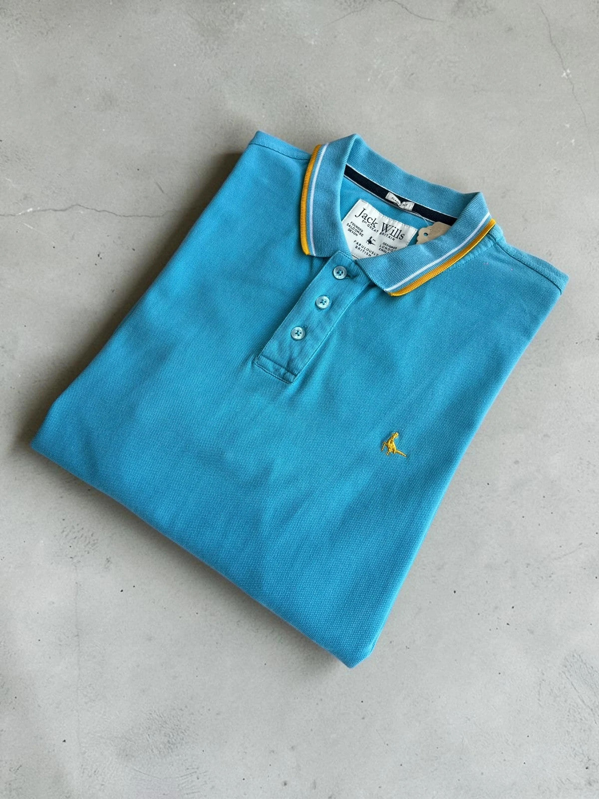 Jack Wills blue polo shirt with yellow collar and sleeve details, classic fit cotton.