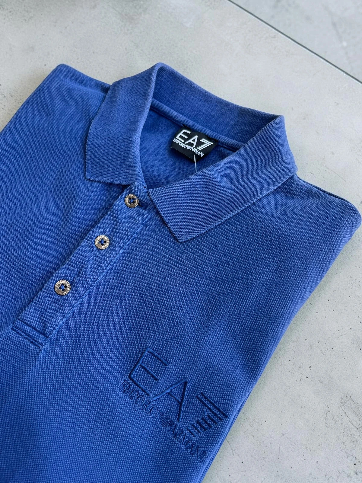 EA7 Emporio Armani blue polo shirt with embroidered logo and classic sporty design.