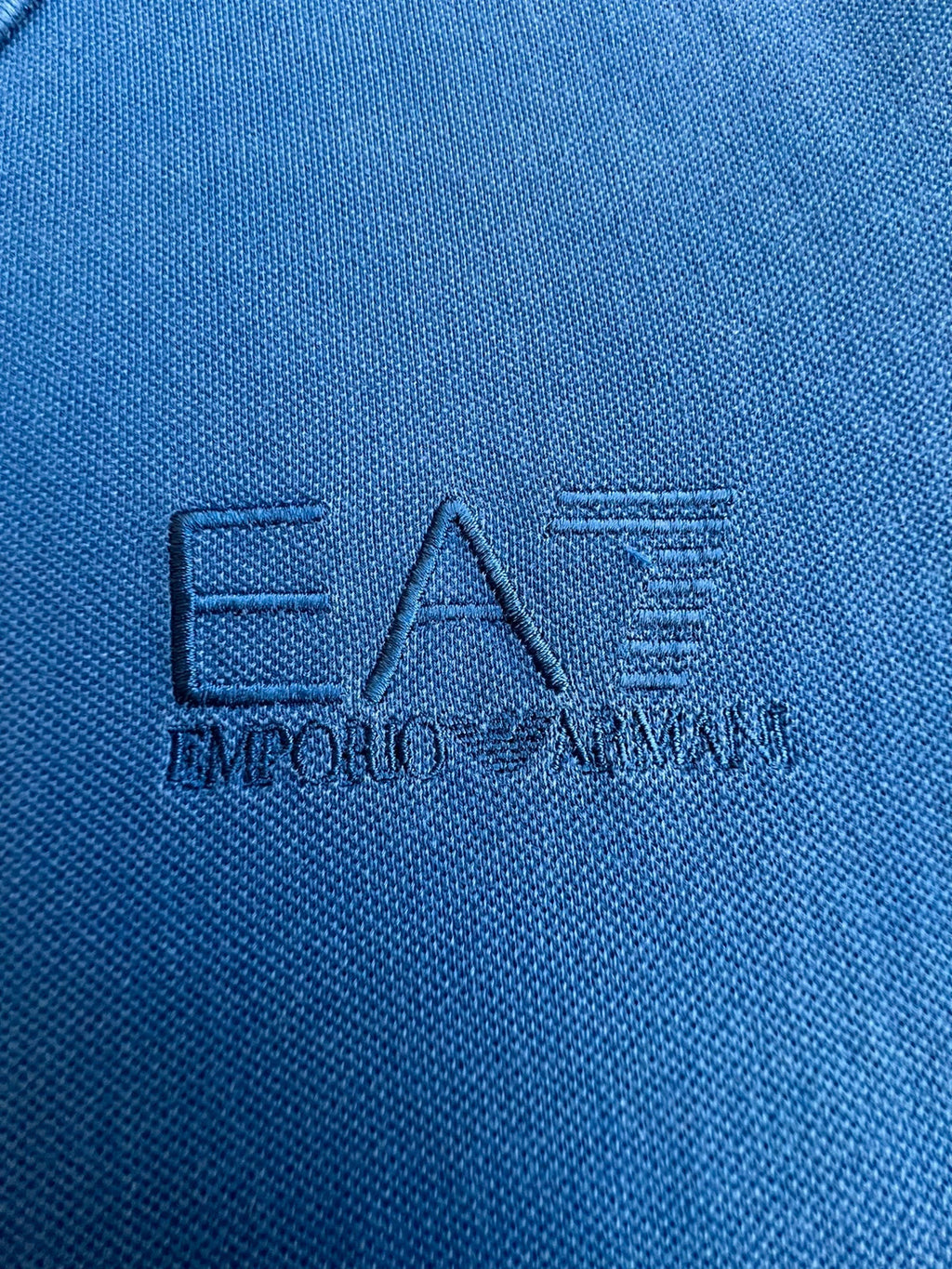 EA7 Emporio Armani blue polo shirt with embroidered logo and classic sporty design.