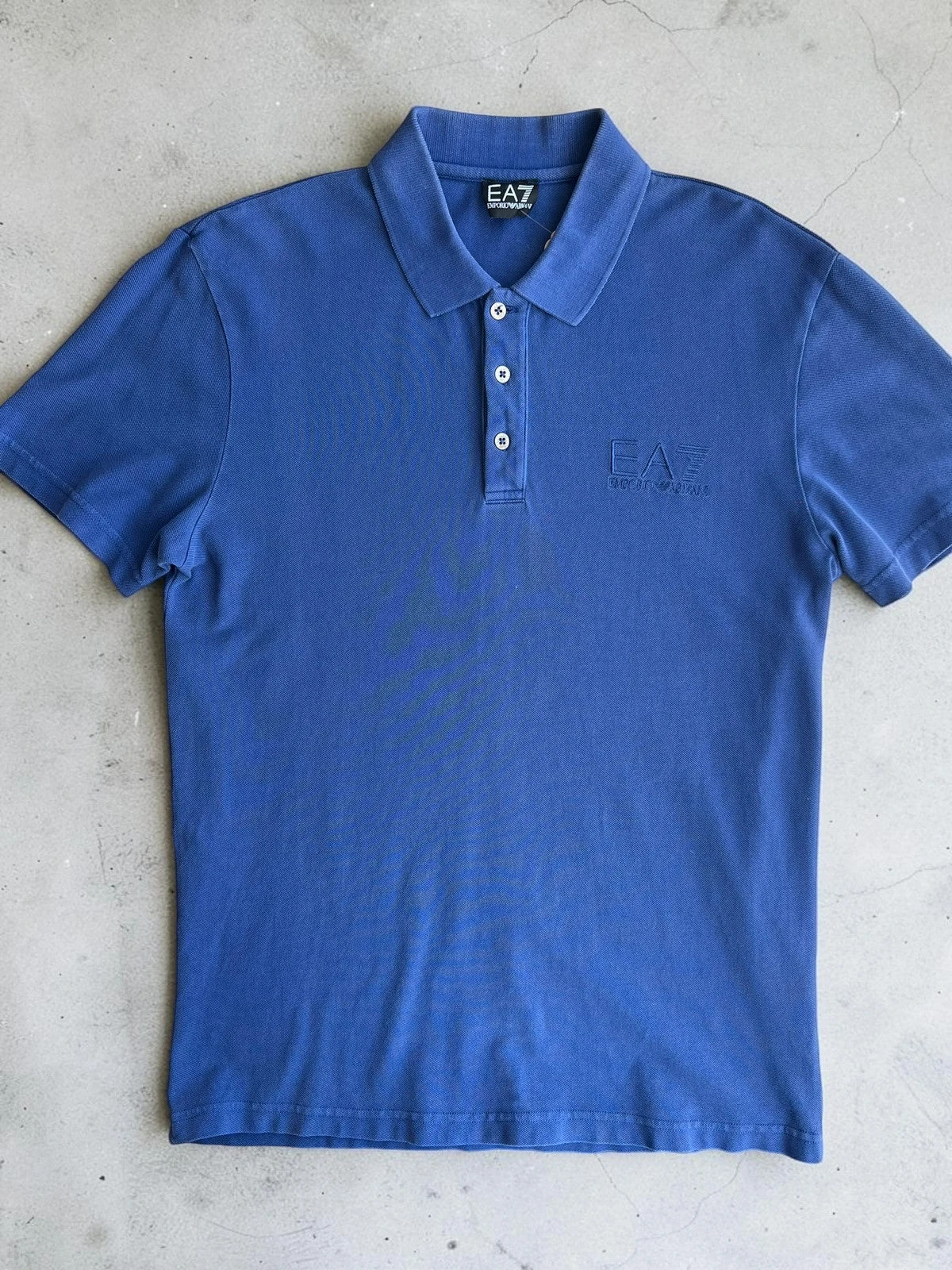 EA7 Emporio Armani blue polo shirt with embroidered logo and classic sporty design.