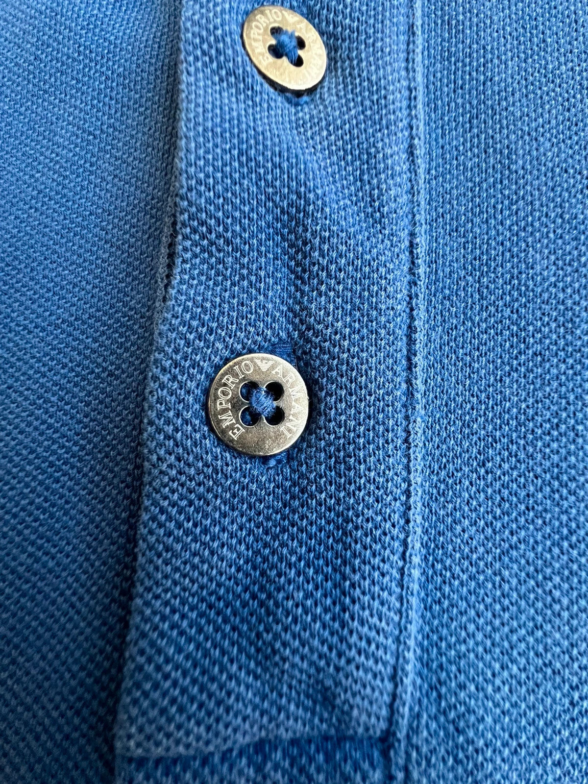 EA7 Emporio Armani blue polo shirt with embroidered logo and classic sporty design.
