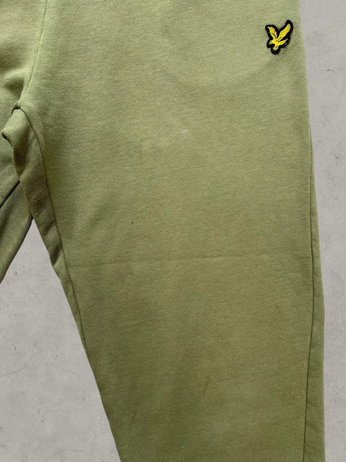 Lyle & Scott khaki joggers with embroidered eagle logo and adjustable waistband.