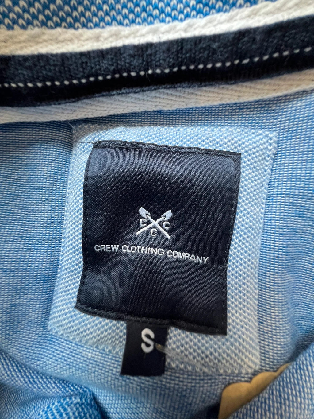 Crew Clothing Company blue polo shirt with embroidered logo and classic piqué fabric.