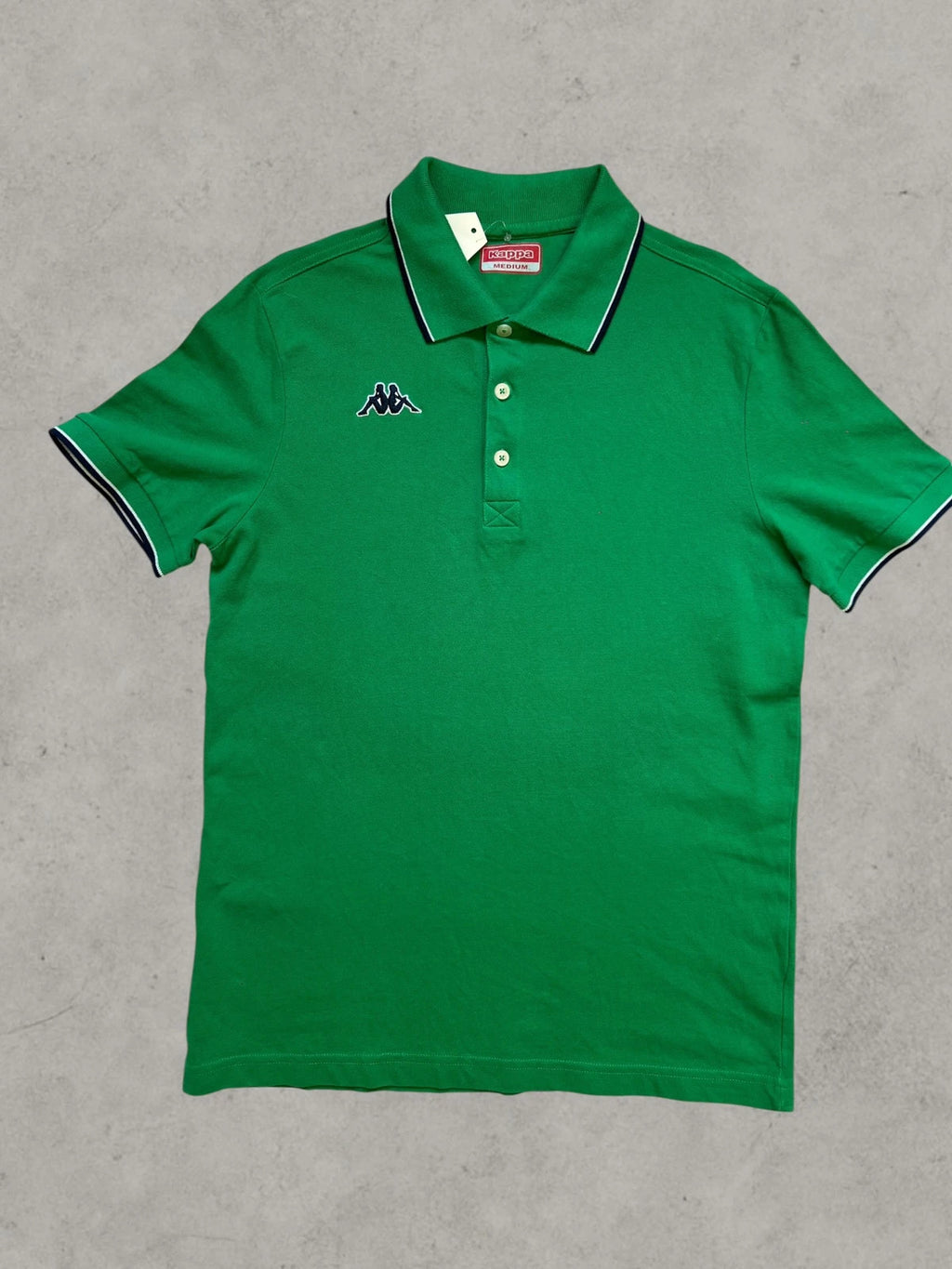 Kappa green polo shirt with embroidered logo and navy-white collar trim.