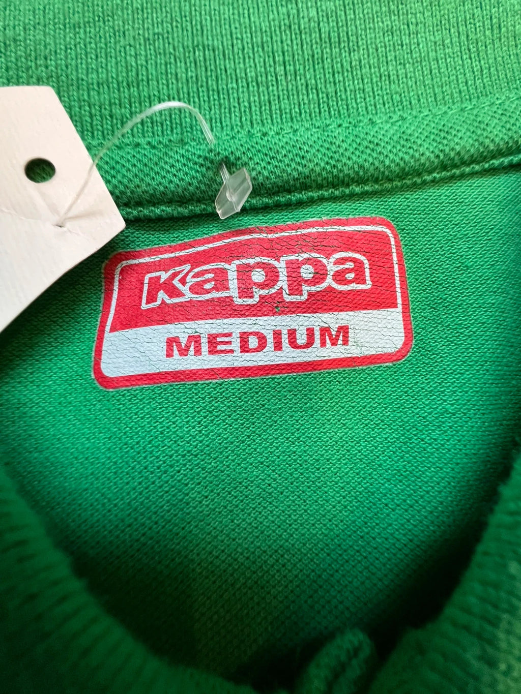 Kappa green polo shirt with embroidered logo and navy-white collar trim.