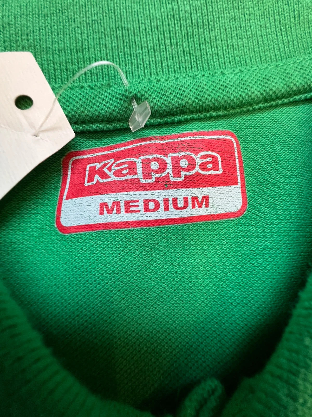 Kappa green polo shirt with embroidered logo and navy-white collar trim.