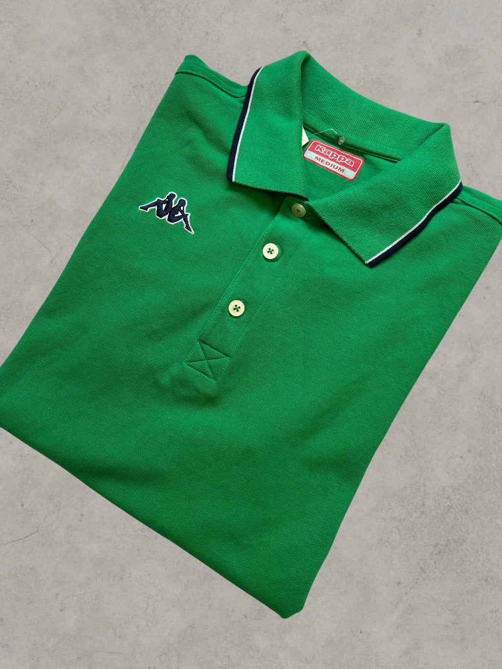 Kappa green polo shirt with embroidered logo and navy-white collar trim.