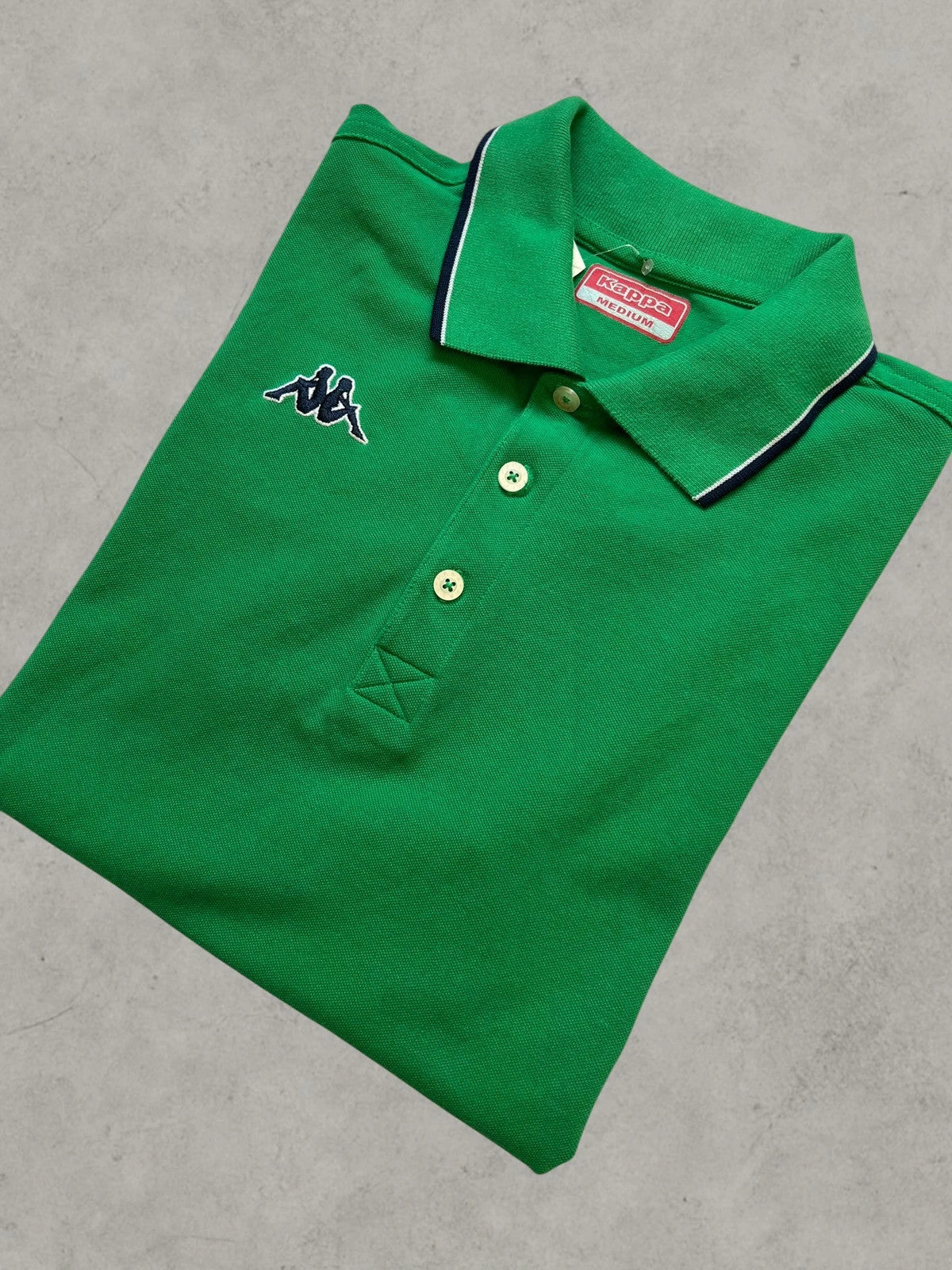 Kappa green polo shirt with embroidered logo and navy-white collar trim.