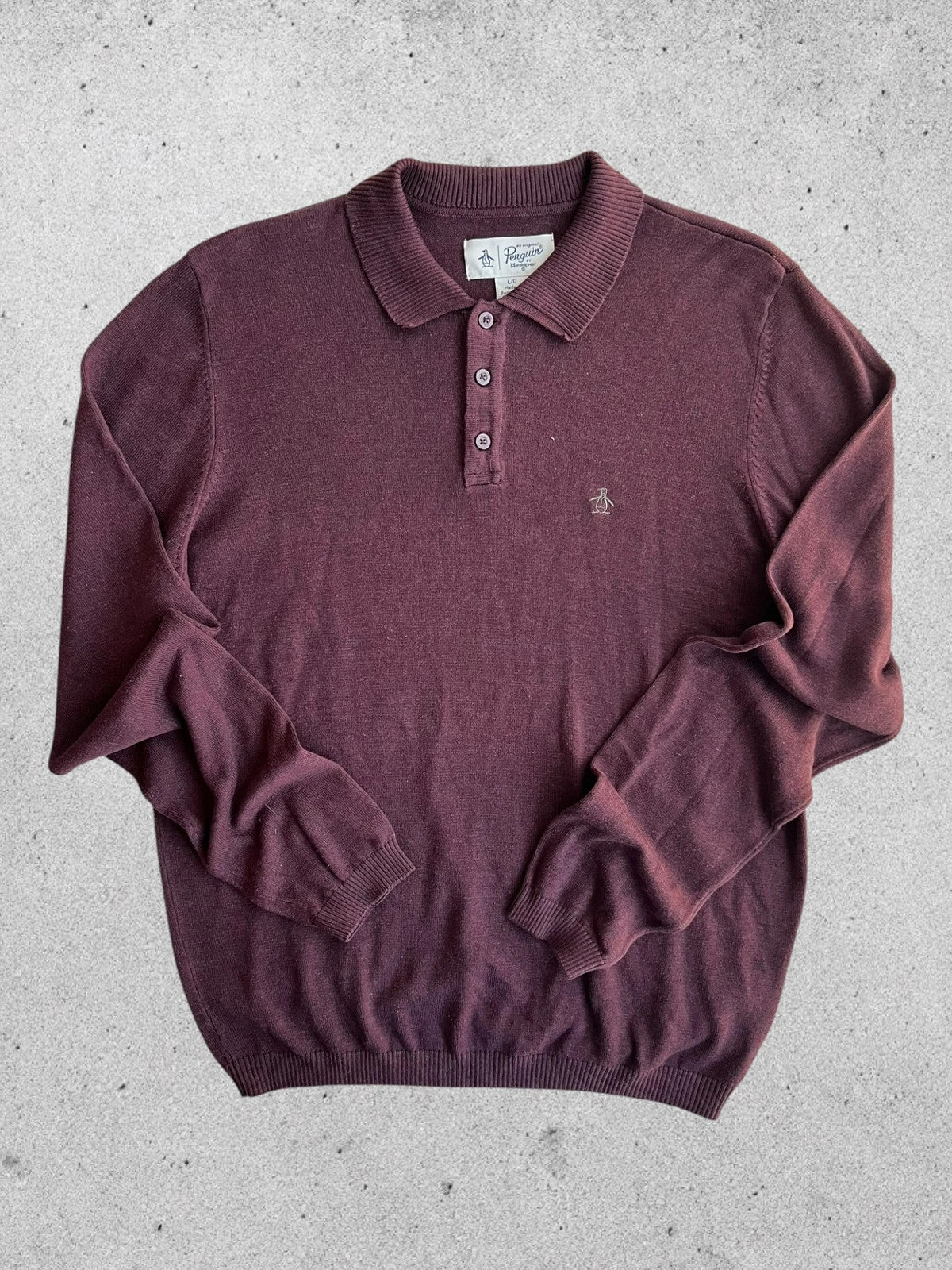 Penguin burgundy jersey polo with button closure and classic collar design.