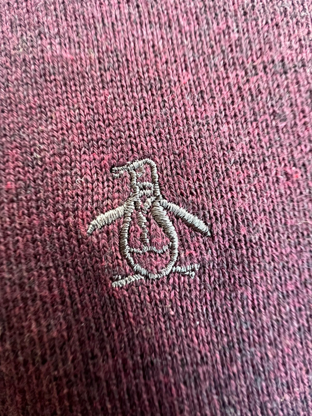 Penguin burgundy jersey polo with button closure and classic collar design.