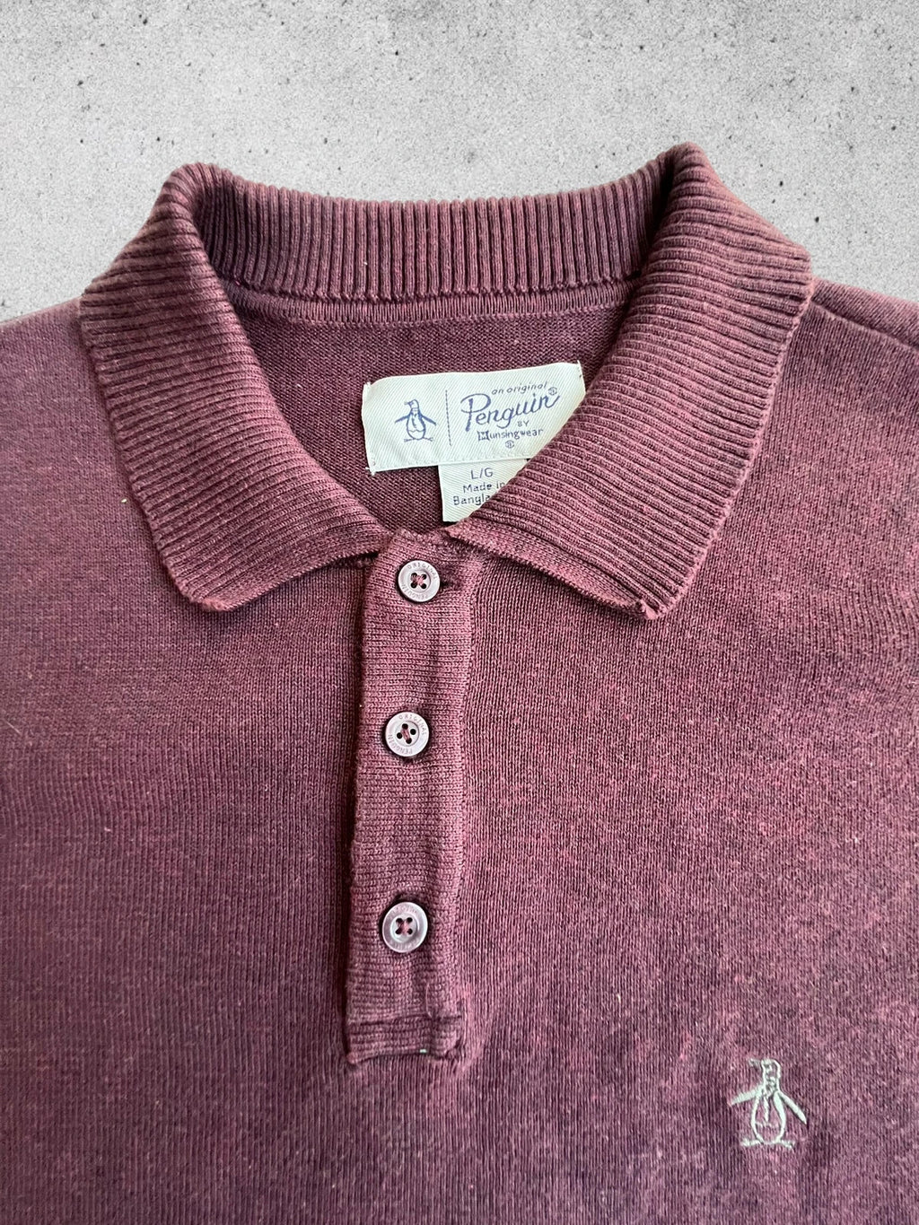 Penguin burgundy jersey polo with button closure and classic collar design.