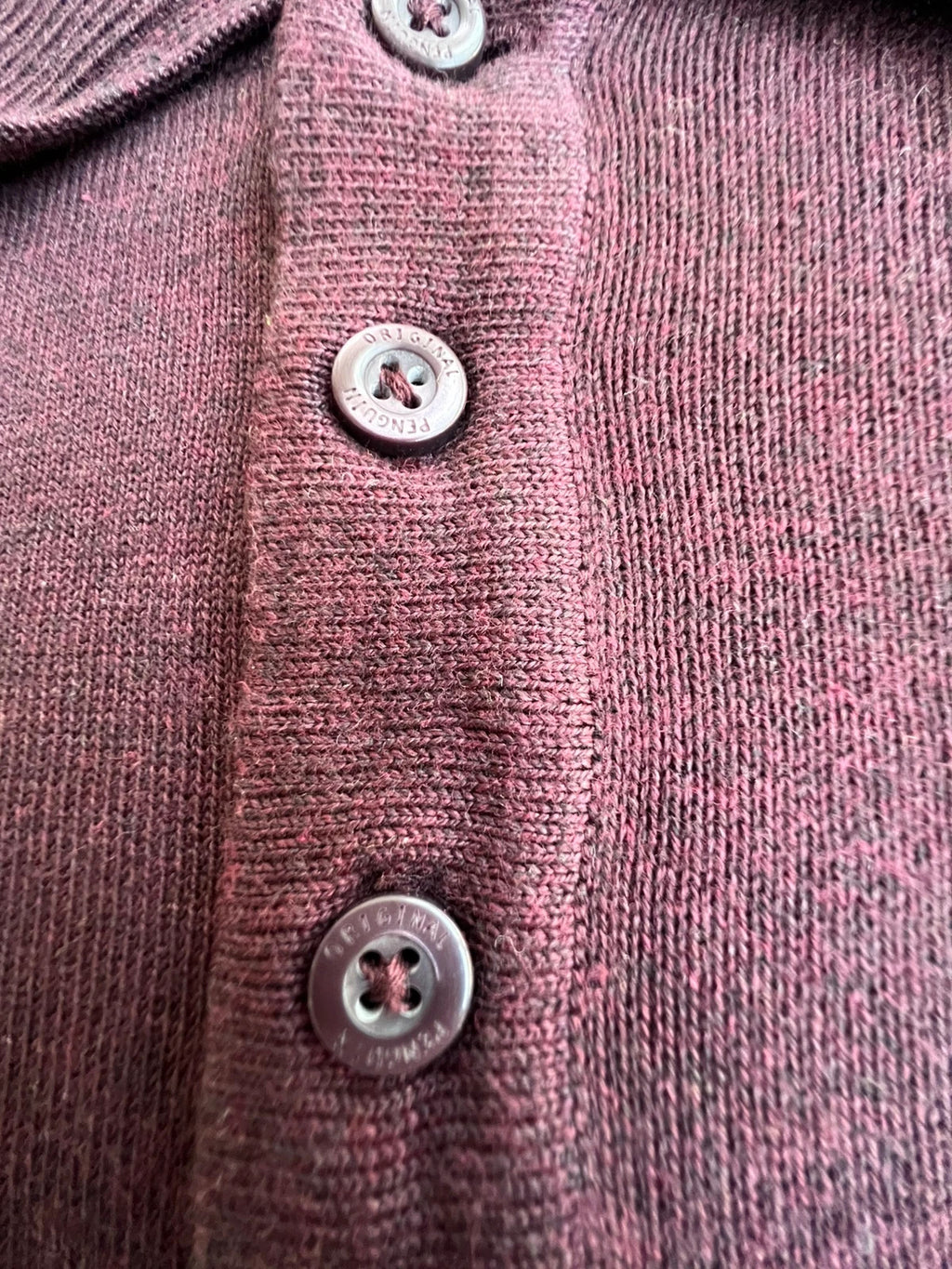 Penguin burgundy jersey polo with button closure and classic collar design.