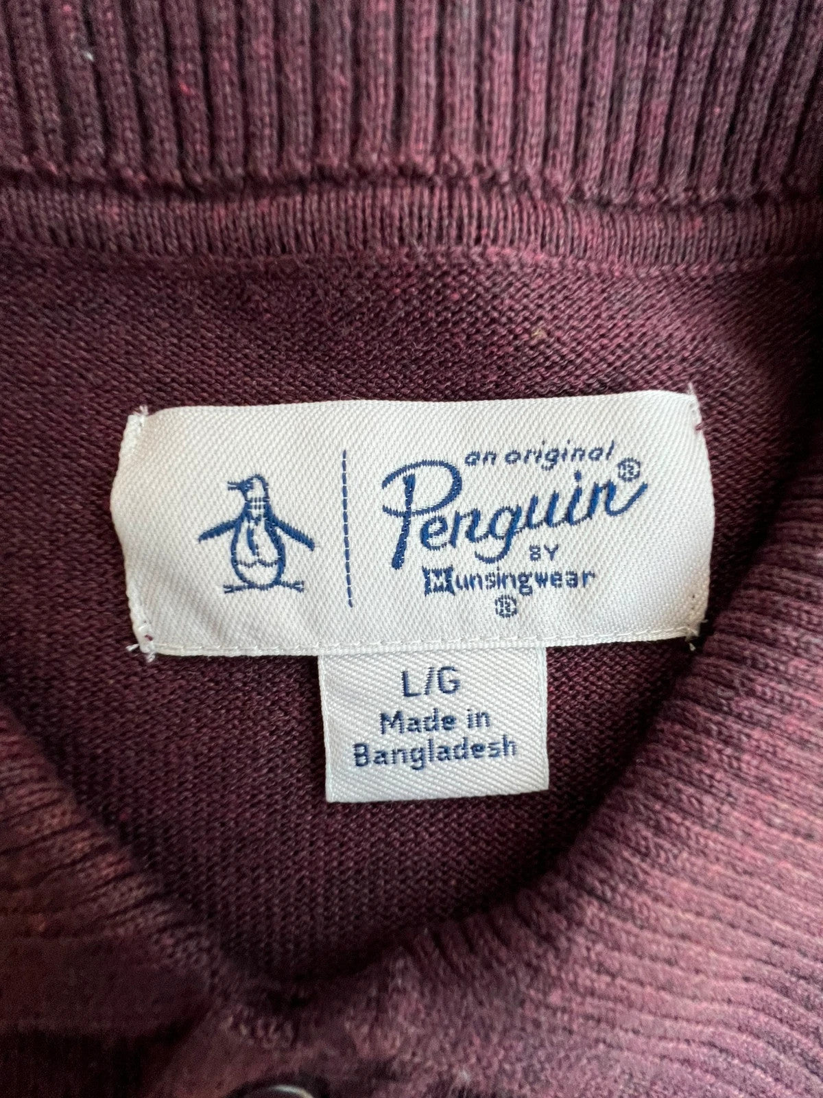 Penguin burgundy jersey polo with button closure and classic collar design.