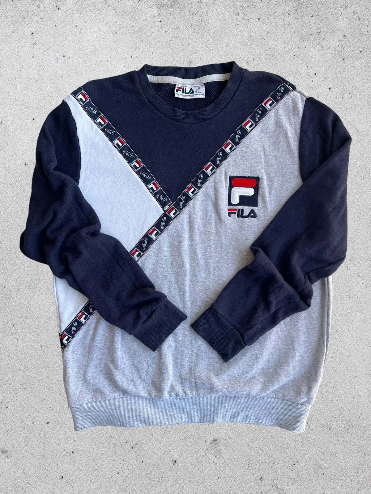 Fila navy sweatshirt with embroidered logo and side branding tapes, 90s retro style.