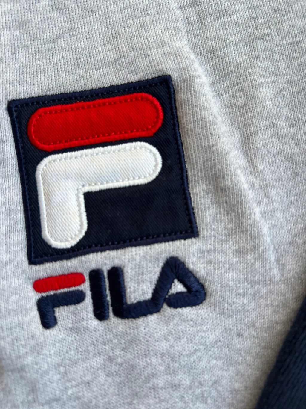 Fila navy sweatshirt with embroidered logo and side branding tapes, 90s retro style.