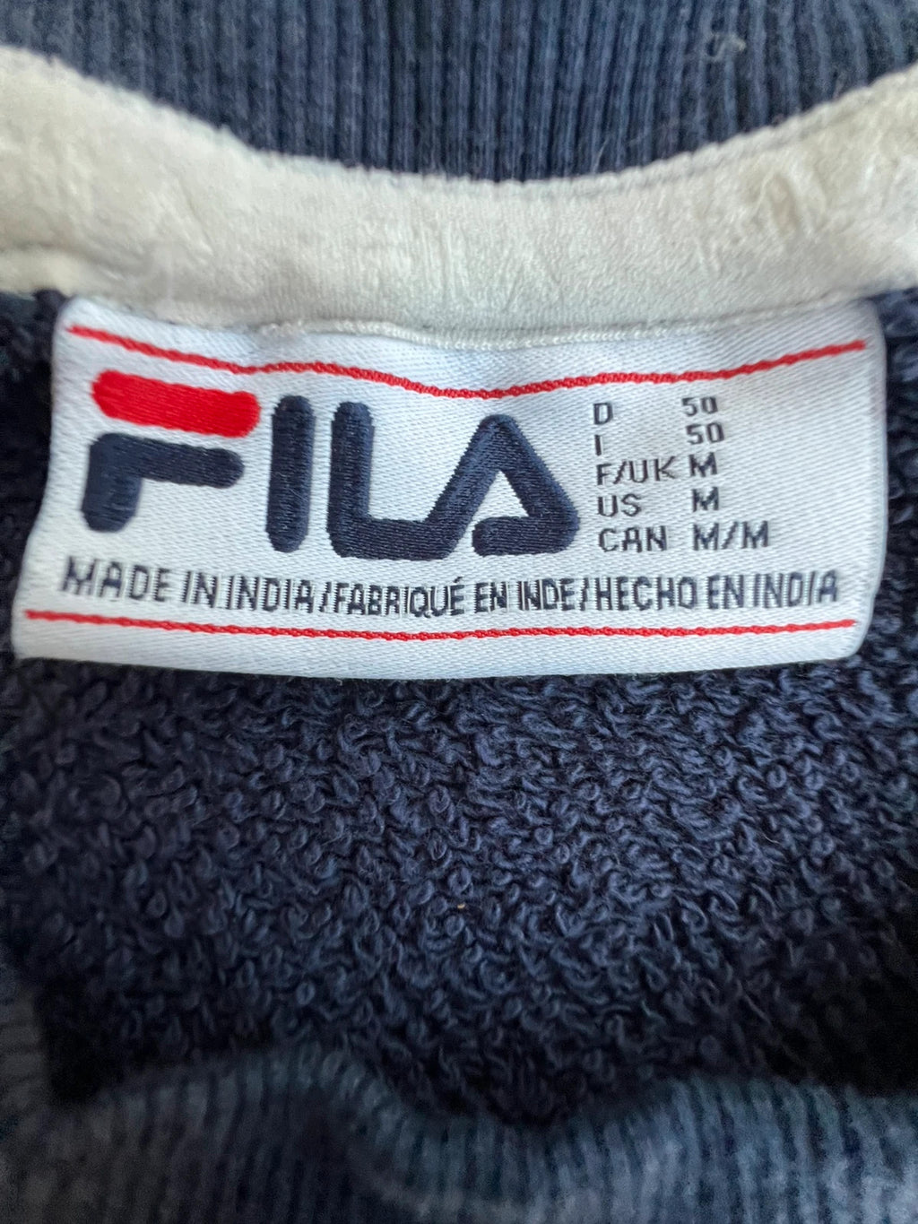 Fila navy sweatshirt with embroidered logo and side branding tapes, 90s retro style.