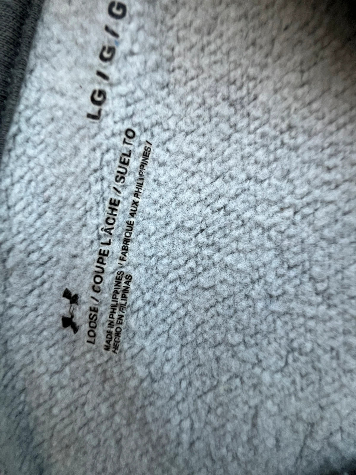 Under Armour grey oversized hoodie with front kangaroo pocket and logo on chest.