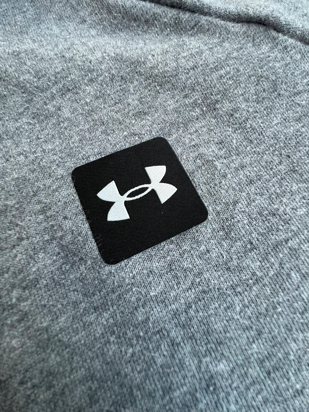 Under Armour grey oversized hoodie with front kangaroo pocket and logo on chest.