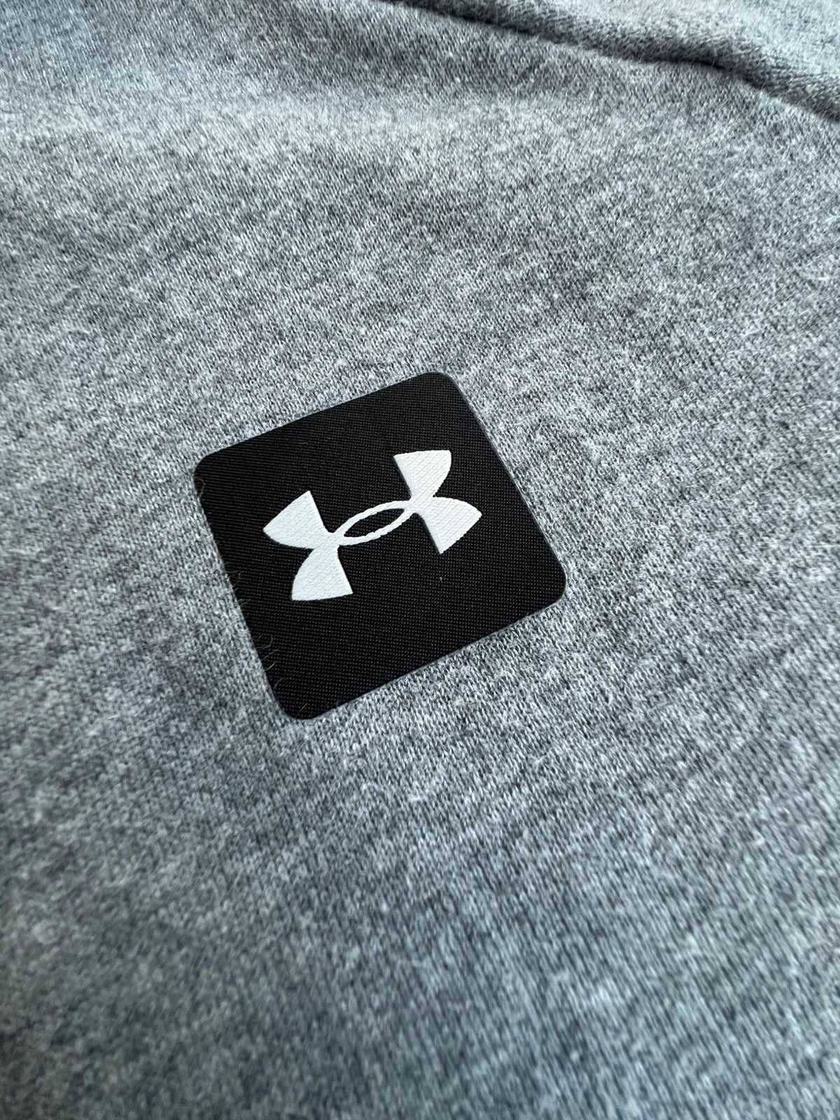 Under Armour grey oversized hoodie with front kangaroo pocket and logo on chest.