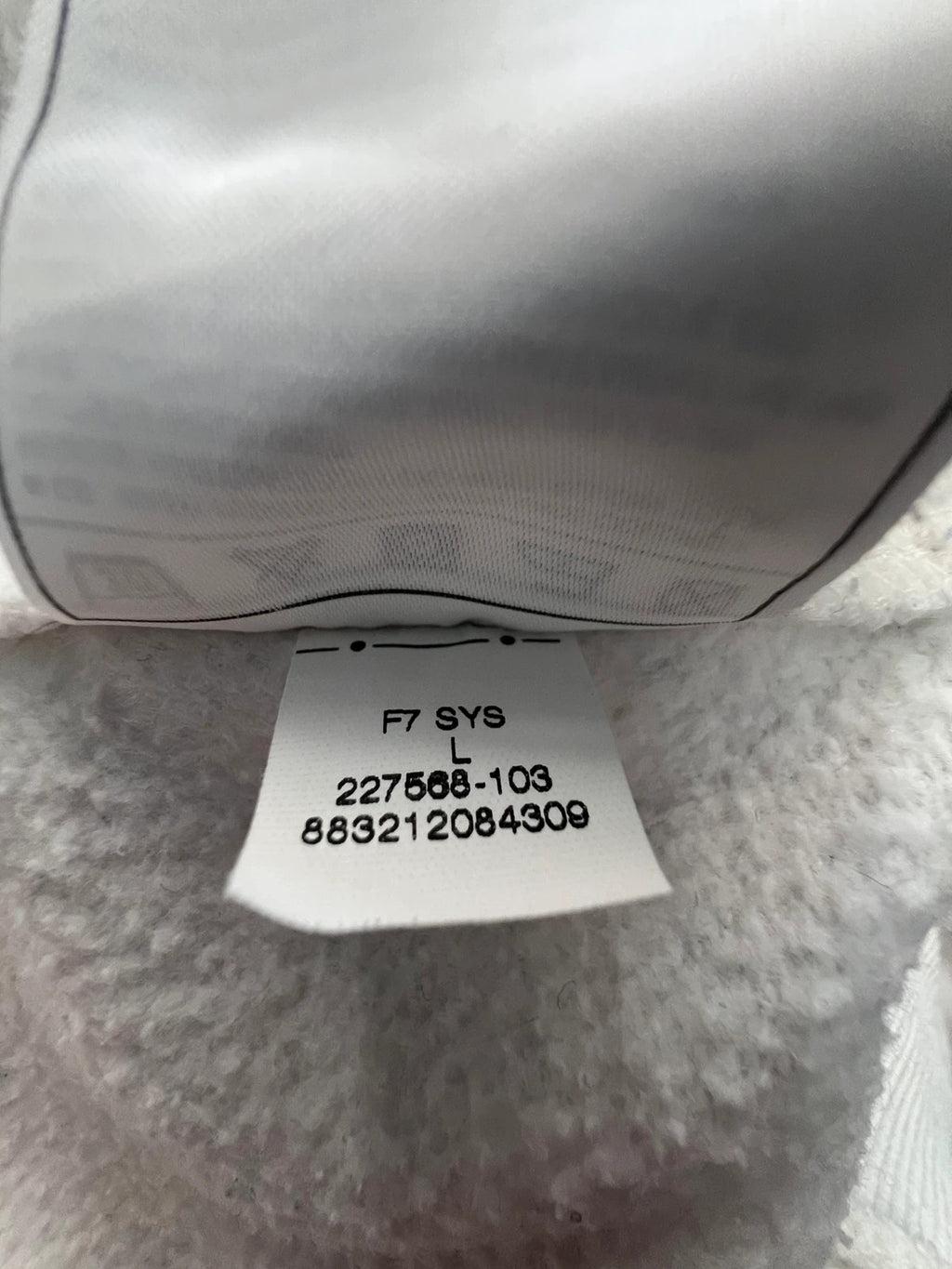 Nike white sweatshirt with beige embroidered logo and fleece interior.