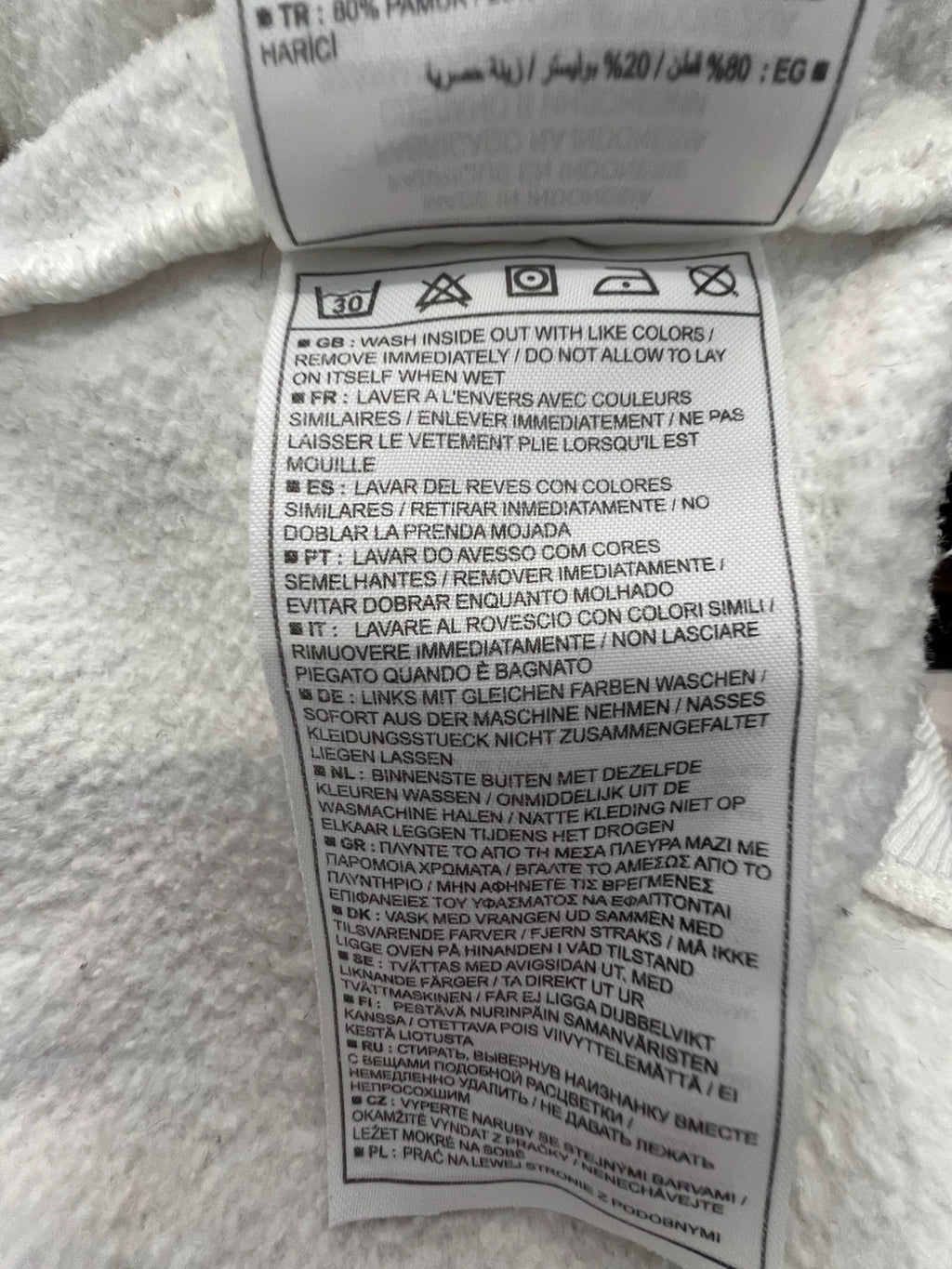 Nike white sweatshirt with beige embroidered logo and fleece interior.