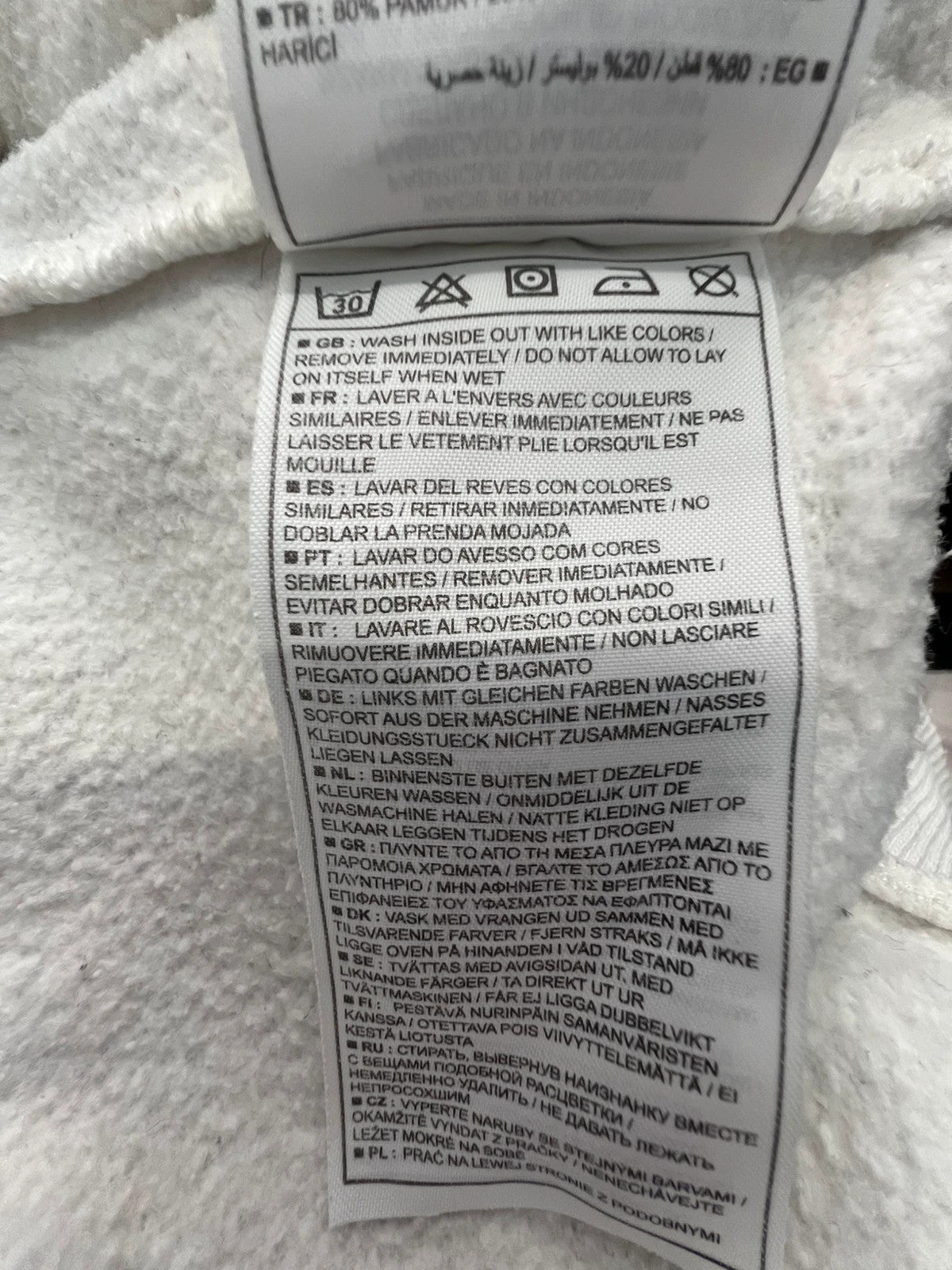 Nike white sweatshirt with beige embroidered logo and fleece interior.