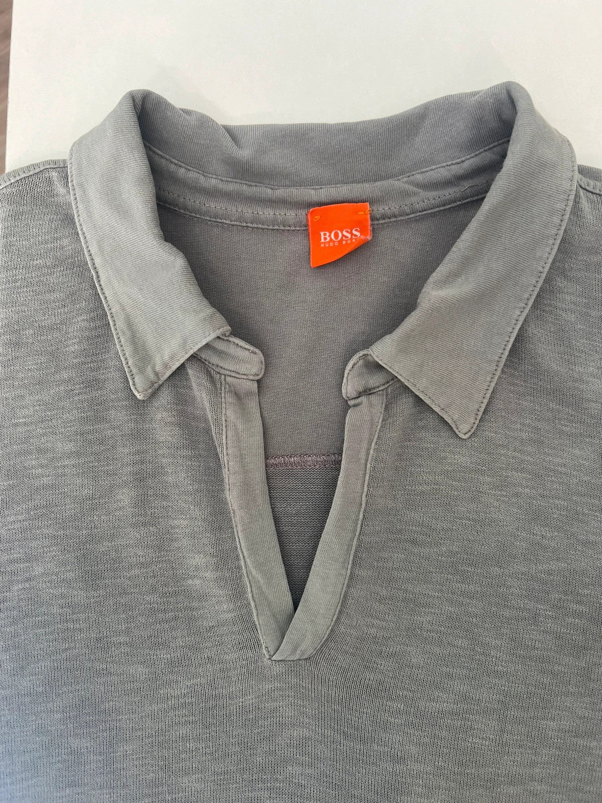 Hugo Boss grey long sleeve polo shirt with open collar and soft cotton fabric.