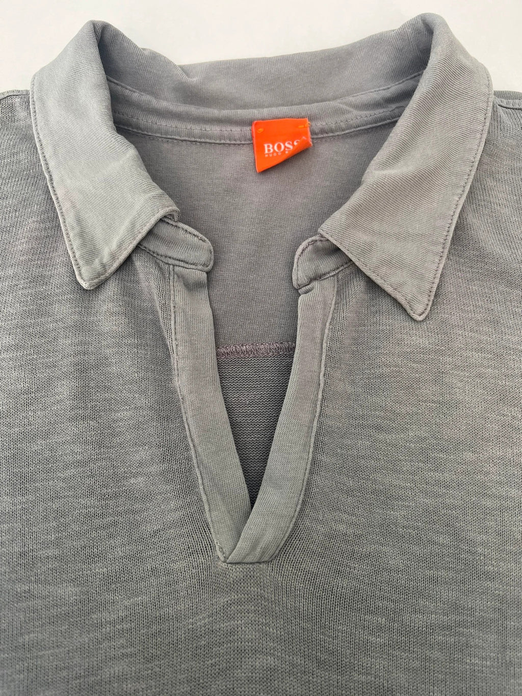 Hugo Boss grey long sleeve polo shirt with open collar and soft cotton fabric.