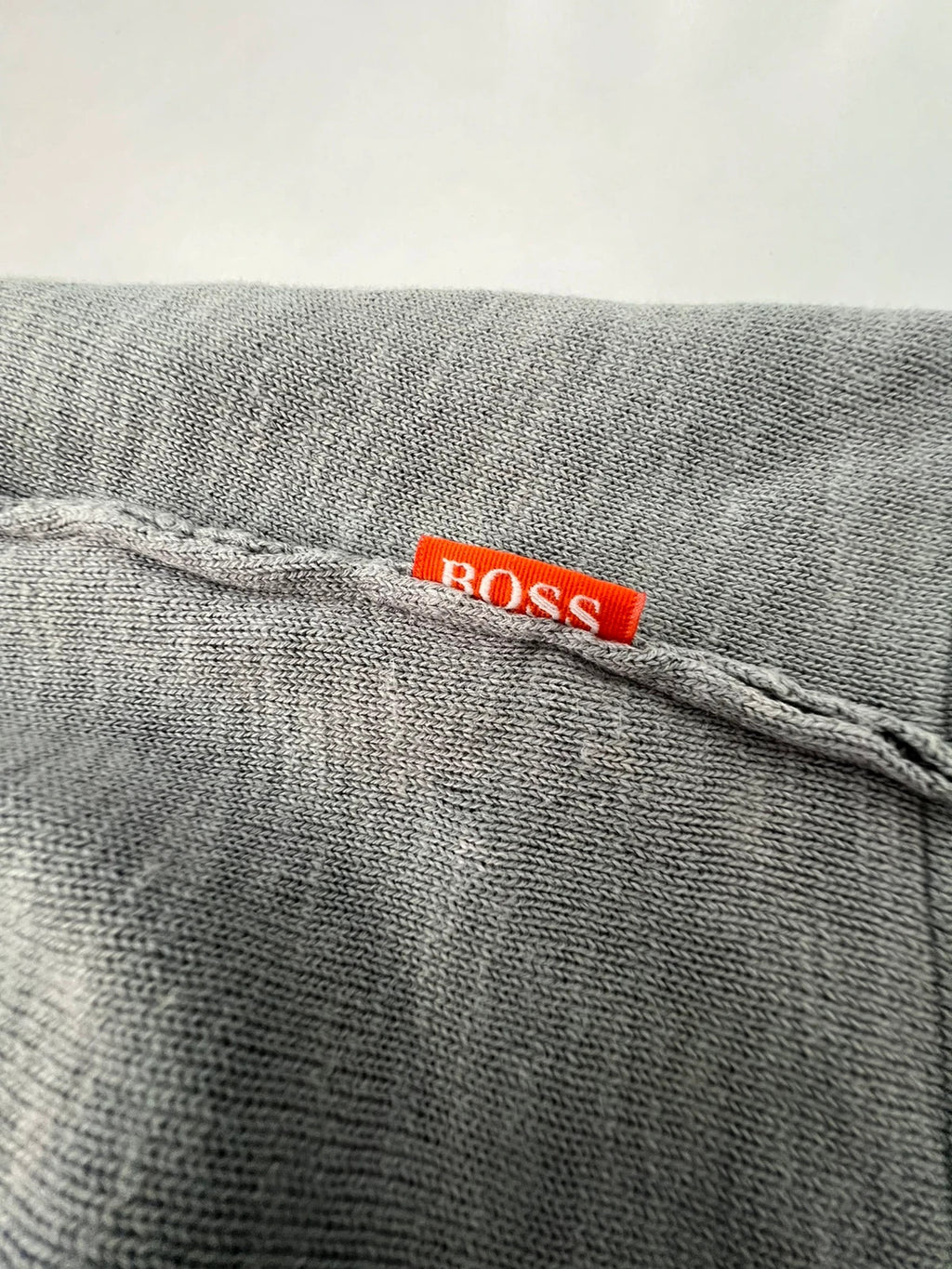 Hugo Boss grey long sleeve polo shirt with open collar and soft cotton fabric.