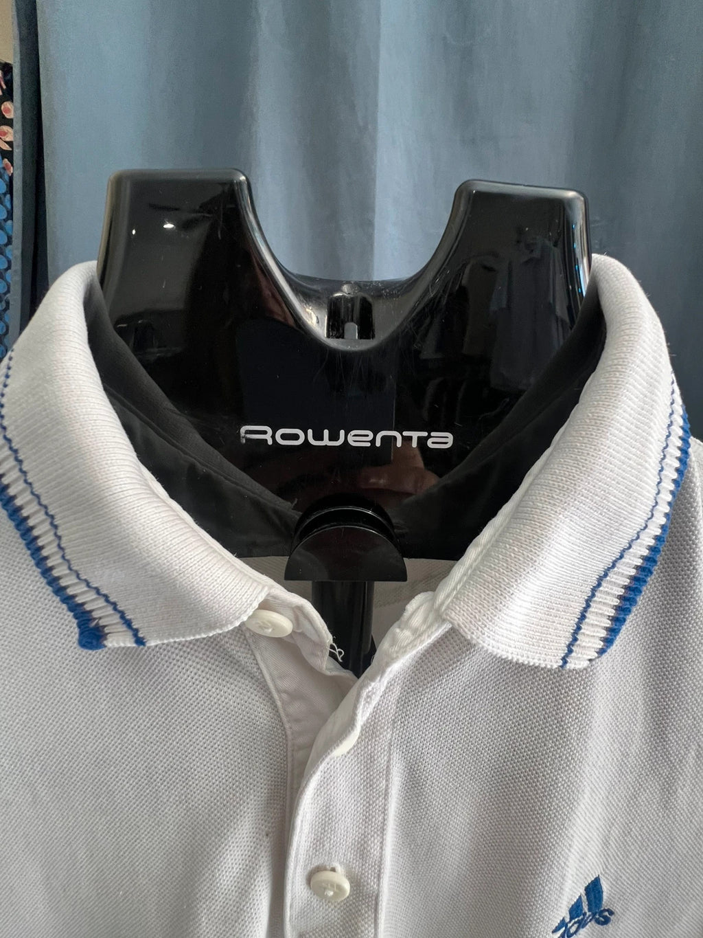 Adidas white polo shirt with embroidered blue logo, vintage Y2K style.