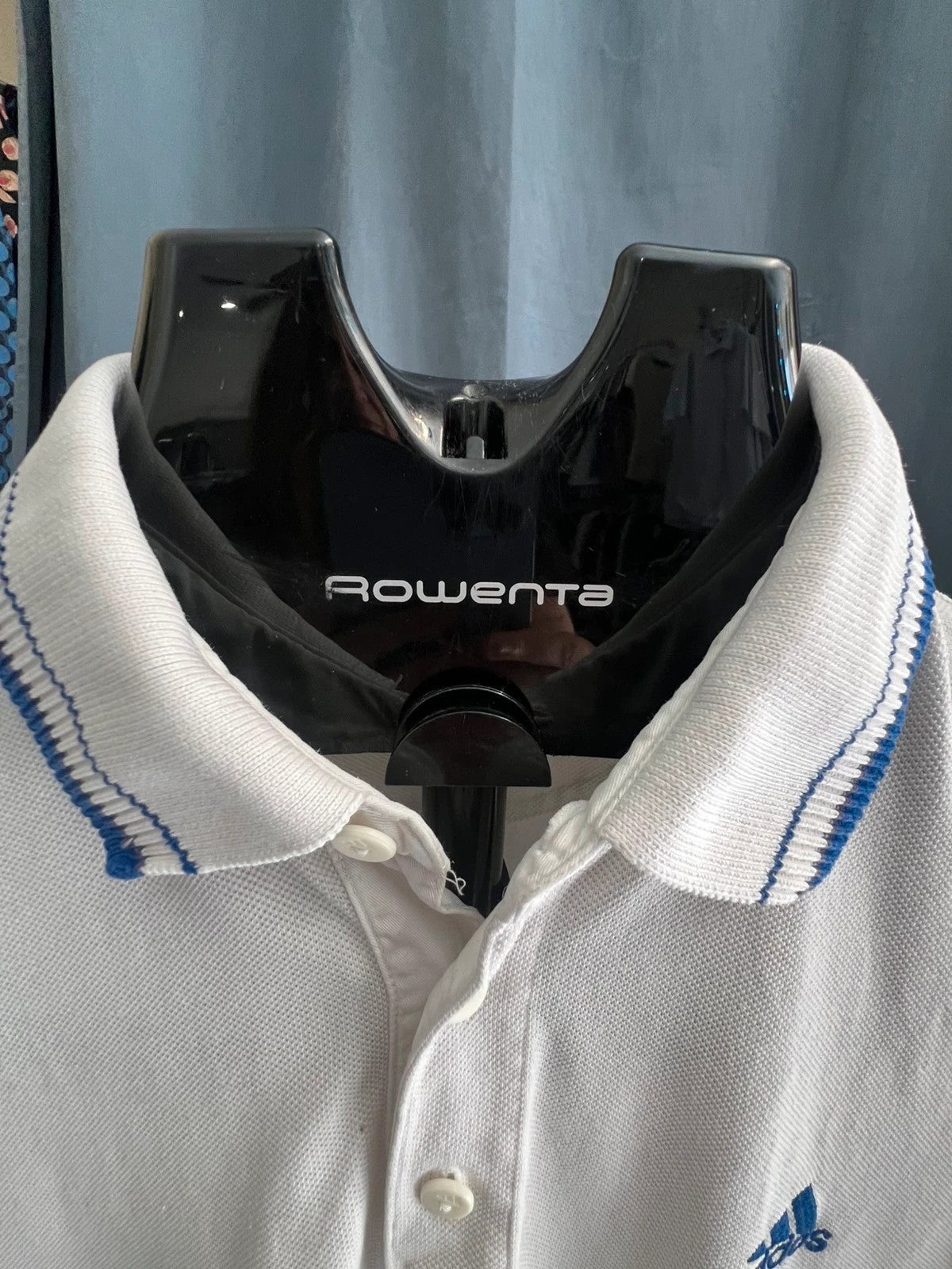 Adidas white polo shirt with embroidered blue logo, vintage Y2K style.