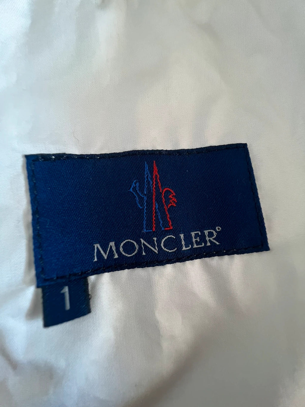 Moncler white gilet with diamond quilted pattern, high collar, and double zipper.