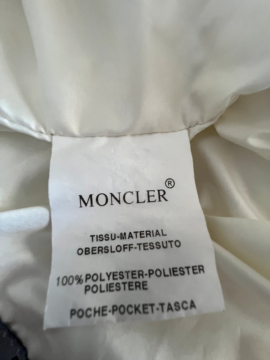 Moncler white gilet with diamond quilted pattern, high collar, and double zipper.